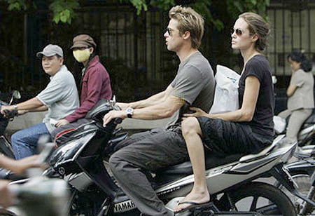 Brad Pitt dùng xe máy trở Angelina Jolie thăm quan chợ Bến Thành và thành phố Hồ Chí Minh. Do cả hai ăn mặc đơn giản, bụi bặm như các Tây ba lô khác nên ít người nhận ra họ. (Ảnh: Tuổi trẻ)