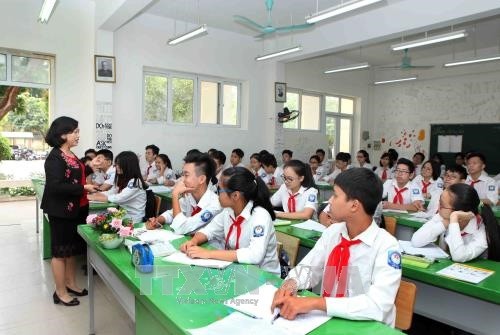 Nhiều giáo viên sợ nhận mức hoàn thành xuất sắc nhiệm vụ vì phải làm sáng kiến kinh nghiệm. Ảnh: TTXVN