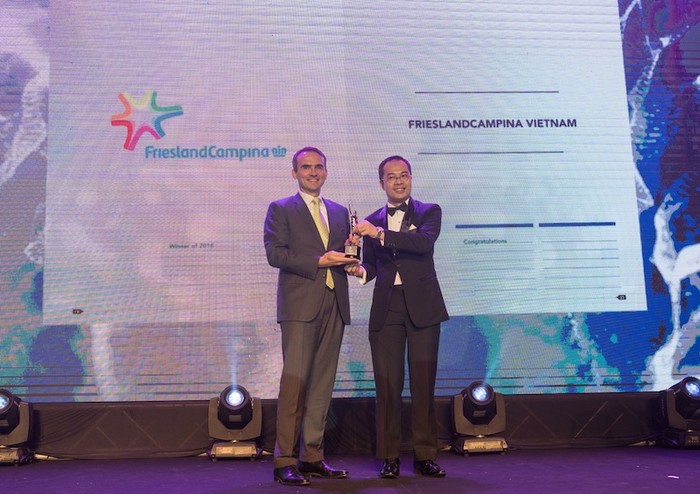 Ông Arnoud van den Berg – Tổng Giám đốc Công ty FrieslandCampina Việt Nam (bên trái) nhận kỷ niệm chương tại buổi lễ công bố