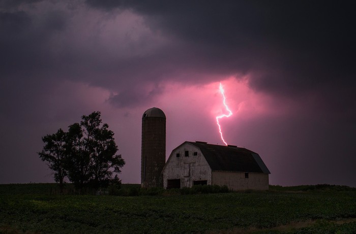 Tia sét đánh xuống phía kho thóc bao quanh bởi cánh đồng cây đậu nành ở Donnellson, Iowa, 13/07/2012.