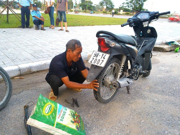 Hàng ngày, ngoài công việc làm thuê chú Định còn tranh thủ đi vá xăm xe. Ảnh Xuân Trung