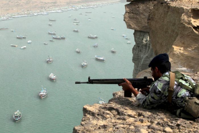 Một người lính Iran đang quan sát tàu thuyền đi qua eo Hormuz