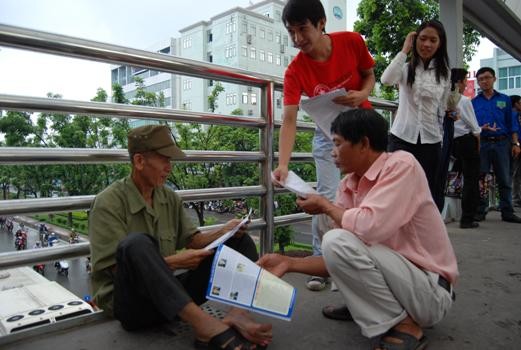 Ông Đoàn Văn Trung trò chuyện với các phụ huynh khác trong lúc đợi cháu thi Đại học (Ảnh: Đỗ Quyên)