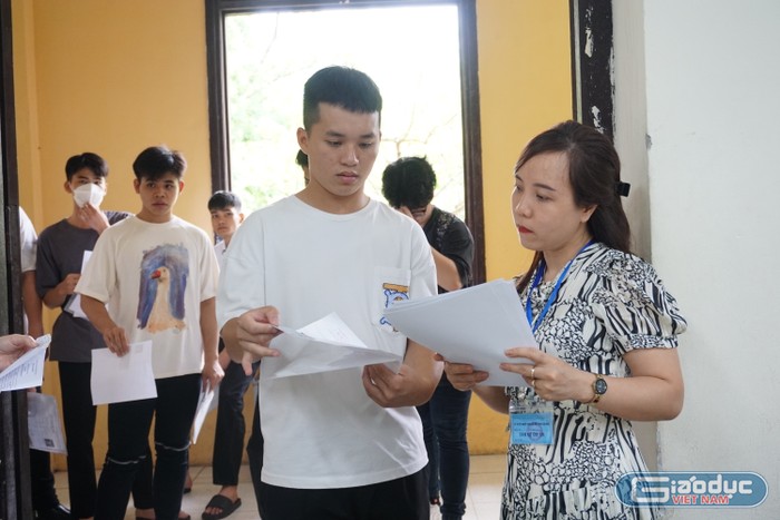 Giám thị kiểm tra thông tin thí sinh, ghi nhận tại điểm thi Trường Trung học Phan Đình Phùng. Ảnh: Minh Phạm