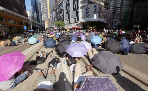 Biểu tình ngoài đường suốt đêm, mệt thì ngủ ngay trên đường phố. Ban ngày nắng gắt, những người biểu tình mang ô ngồi và nằm giữa đường phố Hồng Kông sau khi đụng độ với cảnh sát.