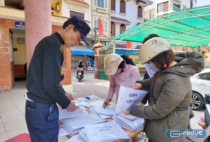 Các phụ huynh tới lấy bài tập cho con tại trường (Ảnh: Lã Tiến)