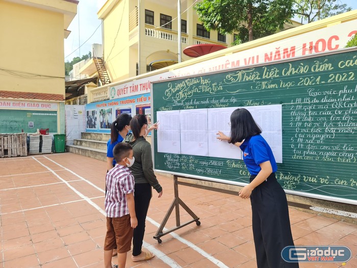 Cán bộ, giáo viên nhà trường tận tình hướng dẫn phụ huynh và học sinh trong ngày đầu tiên tới trường (Ảnh: Lã Tiến)