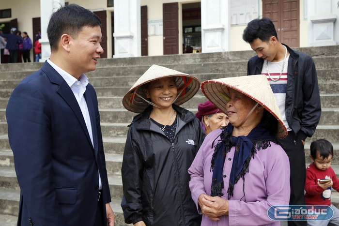 Nhà báo Nguyễn Tiến Bình - Tổng biên tập Báo điện tử Giáo dục Việt Nam, đang hỏi thăm đời sống của bà Lê Thị Gái 83 tuổi. Ảnh: Tùng Dương.