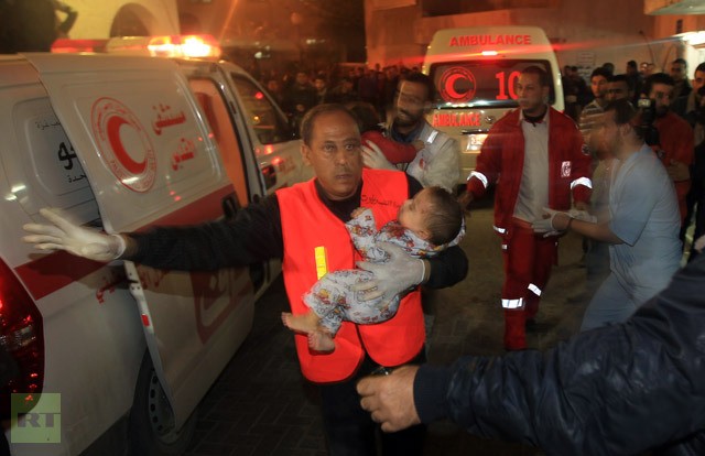 Các nhân viên y tế Palestine giúp người dân Dải Gaza bị thương tới bệnh viện.