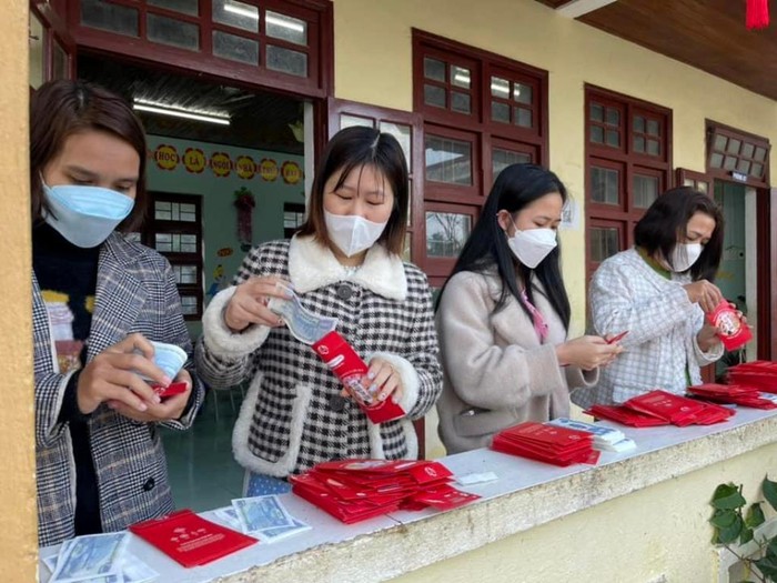 Các giáo viên tại các trường chuẩn bị phong bao lì xì cho học sinh. Ảnh: NTV